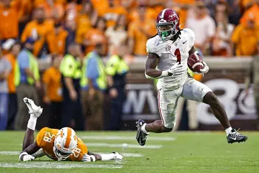 Alabama running back Jahmyr Gibbs (1) gets past Tennessee defensive back De'Shawn Rucker (28) during the second half of an NCAA college football game Saturday, Oct. 15, 2022, in Knoxville, Tenn. Tennessee won 52-49. (AP Photo/Wade Payne)