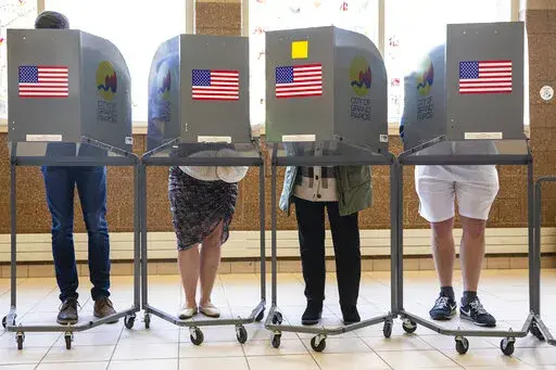 People cast their ballots at Coit Arts Academy in Grand Rapids on Tuesday, Nov. 8, 2022. On a successful, high-profile ballot measure in the battleground state of Michigan, proposing to enshrine abortion rights in the state constitution, Catholic voters split about evenly, according to AP VoteCast, an expansive survey of more than 94,000 voters across the country. (Joel Bissell/The Grand Rapids Press via AP, File)
