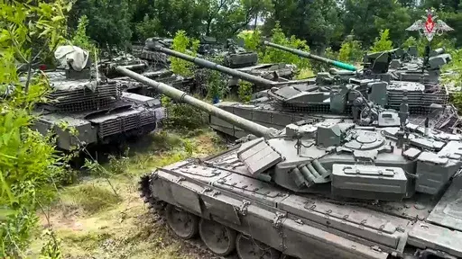 In this photo released by Russian Defense Ministry Press Service on Wednesday, July 12, 2023, Tanks belonging to Russia's Wagner military contractor are parked ahead of their handover to the Russian military at an undisclosed location. The Russian Defense Ministry said that Wagner Group is completing the handover of its weapons to the Russian military. The move follows Wagner's short-lived mutiny last month that challenged the Kremlin. (Russian Defense Ministry Press Service via AP)