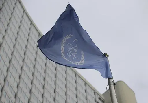 The flag of the International Atomic Energy Agency flies in front of its headquarters during an IAEA Board of Governors meeting in Vienna, Austria, on Feb. 6, 2023. (AP Photo/Heinz-Peter Bader, File)