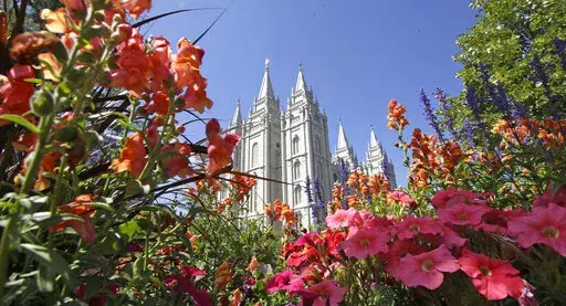 Flowers bloom in front of the Salt Lake Temple, at Temple Square, on Aug. 4, 2015, in Salt Lake City. The Church of Jesus Christ of Latter-day Saints on Tuesday, Nov. 15, 2022, came out in support of The Respect for Marriage Act under consideration in Congress after years of opposing recognition of same-sex marriage. (AP Photo/Rick Bowmer, File)