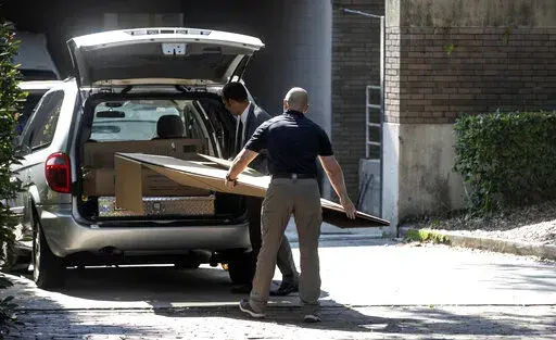 Law enforcement personnel work outside at the Orlando Museum of Art Orlando, Fla., Friday, June 24, 2022. The FBI raided a Florida art museum on Friday and seized more than two dozen paintings attributed to artist Jean-Michel Basquiat following questions about their authenticity.  (Willie J. Allen Jr./Orlando Sentinel via AP)