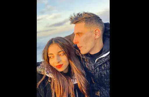 In this photo provided by Chaima Ben Mahmoude, Ben Mahmoude, left and her fiancé pose for a selfie on a boat as they cross the Mediterranean on their way to Europe, Dec. 11, 2021. Two Tunisian women have sparked controversy after they posted videos of their migrant journeys to Europe by boat. The posts illustrate how many young North Africans have become desensitized to the risks of migration and how social media has glamorized an often fatal journey in which around 23,000 people have gone miss