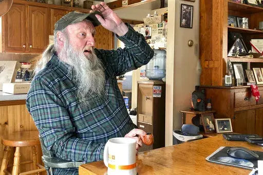 Ray Kemble talks about his water issues in his home in Dimock, Pa., Feb. 14, 2022. Kemble recently met with officials in the Pennsylvania attorney general's office regarding the criminal case against a gas driller charged with polluting Dimock's groundwater with methane. Faulty gas wells drilled by Cabot Oil & Gas were blamed for leaking methane into the groundwater in Dimock, in one of the best-known pollution cases ever to emerge from the U.S. drilling and fracking boom. (AP Photo/Mike Rubinka