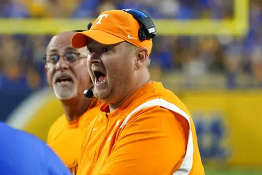 Tennessee head coach Josh Heupel yells to an official after Pittsburgh wide receiver Jared Wayne (5) made a catch along the sideline that was ruled a catch during overtime of an NCAA college football game, Saturday, Sept. 10, 2022, in Pittsburgh. After review, the catch call was overturned. Tennessee won 34-27 in overtime. (AP Photo/Keith Srakocic)