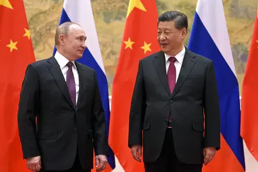 Chinese President Xi Jinping, right, and Russian President Vladimir Putin talk to each other during their meeting in Beijing, Feb. 4, 2022. China is the only friend that might help Russia blunt the impact of economic sanctions over its invasion of Ukraine, but President Xi Jinping’s government is giving no sign it might be willing to risk its own access to U.S. and European markets by doing too much. (Alexei Druzhinin, Sputnik, Kremlin Pool Photo via AP, File)