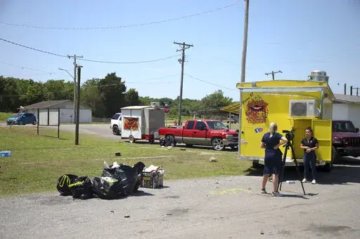 News crews film at the scene of a fatal shooting that happened at a Memorial Day event in Taft, Okla., on Sunday, May 29, 2022. (Ian Maule/Tulsa World via AP)