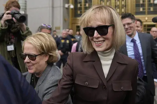 E. Jean Carroll, right, walks out of Manhattan federal court, May 9, 2023, in New York. The notorious 2005 “Access Hollywood” video in which Donald Trump was caught on a hot mic speaking disparagingly about women over a decade before he became president can be shown to jurors deciding what he owes Carroll, a columnist he defamed, a federal judge ruled Tuesday, Jan. 9, 2024, as he set up ground rules for a trial next week. (AP Photo/Seth Wenig, File)