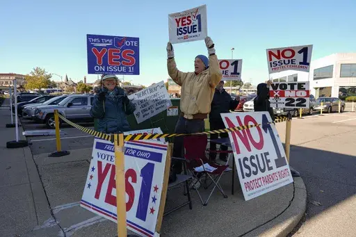 People gather in a parking lot as people arrive for early in-person voting in Cincinnati, Nov. 2, 2023. Ohio is expected to play a starring role in the 2024 high-stakes races for state supreme court seats. The Ohio Supreme Court’s 4-3 Republican majority could flip to Democrats’ favor in the fall if the party sweeps the three seats up for election this year. (AP Photo/Carolyn Kaster, File)