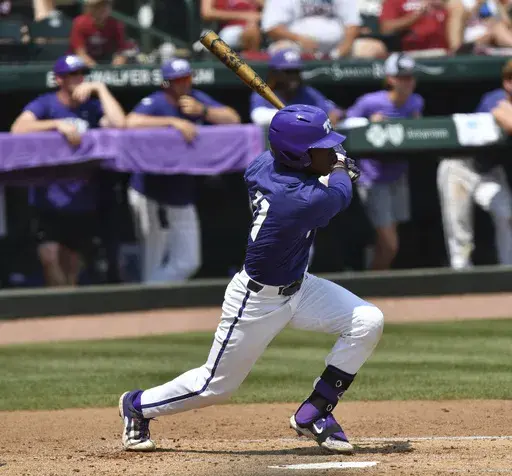 TCU's Austin Davis connects with two-run single against Arkansas during the second inning of an NCAA college baseball tournament regional championship game in Fayetteville, Ark. Monday, June 5, 2023. (Andy Shupe/The Northwest Arkansas Democrat-Gazette via AP)