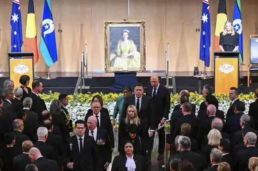 Australian Governor-General David Hurley, center left, and Australian Prime Minister Anthony Albanese, rear center left, leave at the end of the national memorial service for Queen Elizabeth II at Parliament House in Canberra, Thursday, Sept. 22, 2022. An Australian national day of mourning for the late Queen Elizabeth II on Thursday centered on Parliament House, where dignitaries placed sprigs of golden wattle, the national floral emblem, in a wreath. (Lukas Coch/AAP Image via AP)