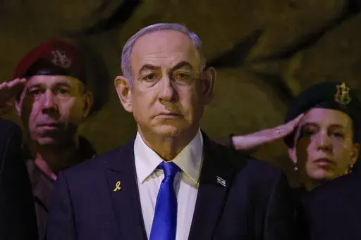 Israeli Prime Minister Benjamin Netanyahu, front, attends a wreath-laying ceremony marking Holocaust Remembrance Day in the Hall of Remembrance at Yad Vashem, the World Holocaust Remembrance Centre, in Jerusalem, Israel, on May 6, 2024. The cease-fire proposal announced by President Joe Biden has placed Prime Minister Netanyahu at a crossroads, with either path likely to shape the legacy of Israel's longest-serving and deeply divisive leader. (Amir Cohen/Pool Photo via AP, File)
