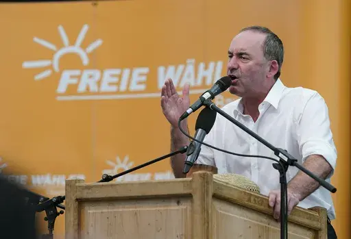Bavarian Minister of State for Economic Affairs, Regional Development and Energy and deputy Governor of Bavaria, Hubert Aiwanger speaks, during a public festival, in Keferloh, Germany, Sunday, Sept, 3, 2023. The governor of the German state of Bavaria said Sunday that he will let his deputy stay in office following a furor that started with allegations he was responsible for an antisemitic flyer when he was a high school student 35 years ago. (Uwe Leindpa via AP)