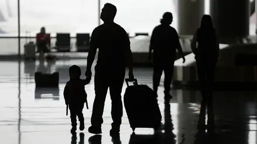 People travel through Salt Lake City International Airport on Wednesday, Feb. 22, 2023, in Salt Lake City. Traveling while pregnant can be tough. Popular travel credit card perks, like free checked bags, seat upgrades and access to airport lounges, can help make you more comfortable while you navigate travel during pregnancy. If there were ever any time to take extra-good care of yourself, it’s now. (AP Photo/Rick Bowmer, File)