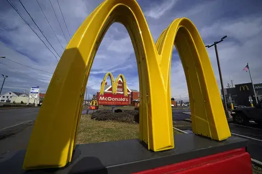 McDonald's restaurant signs are shown in in East Palestine, Ohio, Feb. 9, 2023. Krispy Kreme stock jumped Tuesday, March 26, 2024, after it announced a deal where McDonald’s restaurants will sell its doughnuts across the country.(AP Photo/Gene J. Puskar, File)