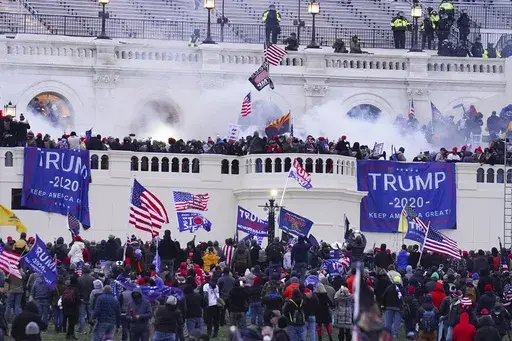 Rioters at the U.S. Capitol on Jan. 6, 2021, in Washington. Frank Rocco Giustino, who skipped court hearings, profanely insulted a prosecutor and berated a federal judge, has been sentenced to three months behind bars for joining the mob that attacked the U.S. Capitol on Jan. 6, 2021. (AP Photo/John Minchillo, File)