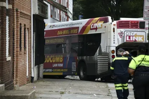 First responders work the scene of a multi-vehicle crash in Baltimore on Saturday, June 17, 2023. Police say several people were injured when a mass transit bus crashed with two cars before hitting a building. (Kim Hairston/The Baltimore Sun via AP)
