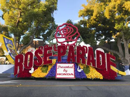 FILE - In this Jan. 1, 2020, file photo, a 2020 Rose Parade float is seen at the start of the route at the 131st Rose Parade in Pasadena, Calif. The Rose Parade and Rose Bowl college football game between Ohio State and Utah were set to go forward on New Year's Day despite surging cases of COVID-19, which forced the cancelation of the 2021 parade. (AP Photo/Michael Owen Baker, File)