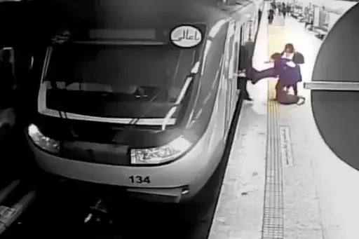 In this image from surveillance video aired by Iranian state television, women pull 16-year-old Armita Geravand from a train car on the Tehran Metro in Tehran, Iran, Sunday, Oct. 1, 2023. The Iranian teenage girl injured weeks ago in a mysterious incident on Tehran's Metro while not wearing a head scarf has died, Iranian state media reported Saturday, Oct. 28.(AP Photo/Iranian state television, File)
