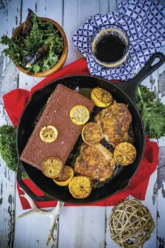 This image released by Ulysses Press shows a recipe for chicken under a brick. This recipe is fast and easy, and will add some victory points to your cooking game. It is gluten-free, sugar-free, dairy-free and low-fat. (Allyson Reedy and Greg McBoat/Ulysses Press via AP)