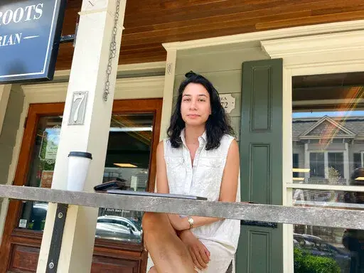Victoria Lowe, an attorney poses for a photo, Friday, June 24, 2022 in Yardley, Pa. Lowe was working on her laptop at a coffee shop when she got word of the Supreme Court's decision on abortion. A tear welled in her eye when she talked about her reaction to the ruling. She said she was upset because women would be losing a right. (AP Photo/Mike Catalini)