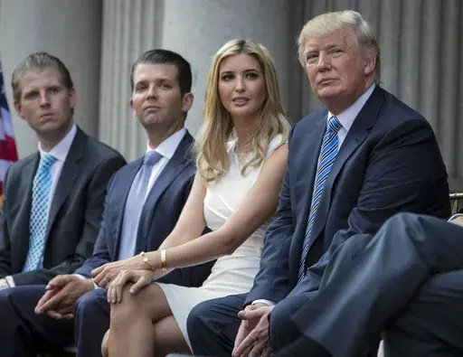 Donald Trump, right, sits with his children, from left, Eric Trump, Donald Trump Jr., and Ivanka Trump during a groundbreaking ceremony for the Trump International Hotel on July 23, 2014, in Washington. A New York appeals court dismissed Ivanka Trump on Tuesday, June 27, 2023, from a wide-ranging fraud lawsuit brought against her father and his company last year by the state's attorney general. (AP Photo/Evan Vucci, File)