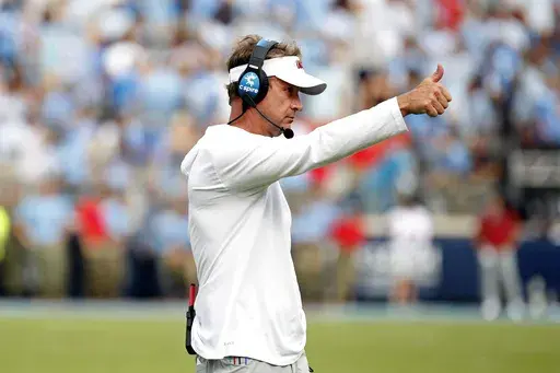 Mississippi head coach Lane Kiffin signals to players during the second half of an NCAA college football game against the Mississippi, Saturday, Oct. 26, 2024, in Oxford, Miss. (AP Photo/Sarah Warnock)