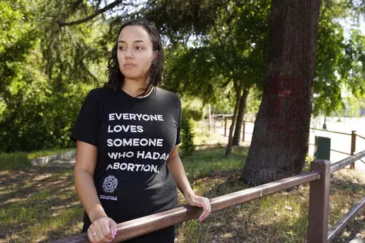 Jessica Pinckney poses at a park near her office in Oakland, Calif., Wednesday, May 4, 2022. California has one statewide abortion fund, known as Access Reproductive Justice. The group helps roughly 500 women each year, about a third whom come from other states, according to executive director Pinckney. (AP Photo/Eric Risberg)
