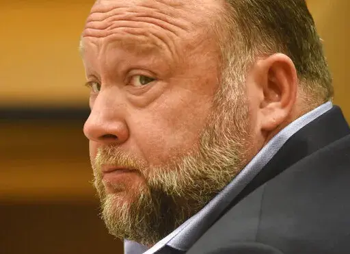Infowars founder Alex Jones appears in court to testify during the Sandy Hook defamation damages trial at Connecticut Superior Court in Waterbury, Conn., on Thursday, Sept. 22, 2022. A six-person jury reached a verdict Wednesday, Oct. 12, 2022, saying that Jones should pay $965 million to 15 plaintiffs who suffered from his lies about the Sandy Hook school massacre. Jones and his company were found liable for damages last year. (Tyler Sizemore/Hearst Connecticut Media via AP, Pool, File)