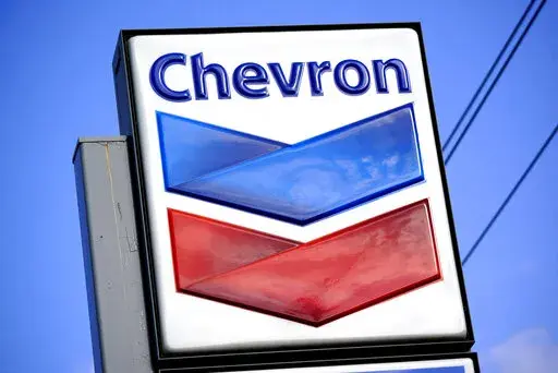 A Chevron sign is displayed outside one of the company's gas stations in Bradenton, Fla., Feb. 22, 2022. The Biden administration is easing some oil sanctions on Venezuela in an effort to support newly restarted negotiations between the Venezuelan government and its opposition. The Treasury Department is allowing Chevron to resume “limited” energy production in Venezuela after years of sanctions that have dramatically curtailed oil and gas profits that have flowed to President Nicolás Madur