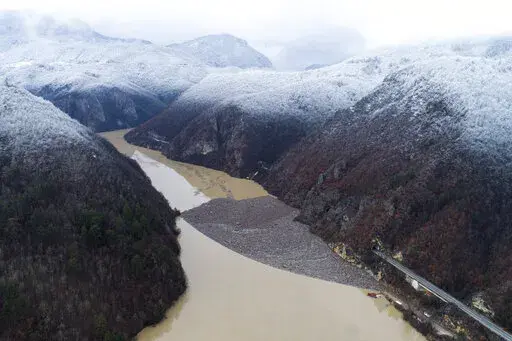 Aerial view of waste floating in the Drina river near Visegrad, Bosnia, Friday, Jan. 20, 2023. Tons of waste dumped in poorly regulated riverside landfills or directly into the rivers across three Western Balkan countries end up accumulating during high water season in winter and spring, behind a trash barrier in the Drina River in eastern Bosnia. (AP Photo/Armin Durgut)
