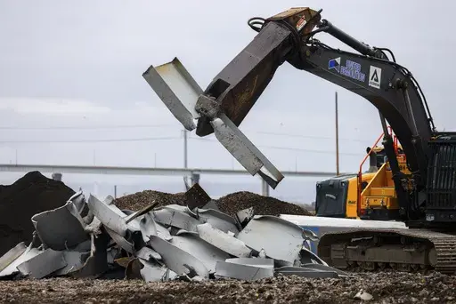 A shearer breaks apart salvaged pieces of the collapsed Francis Scott Key Bridge at Tradepoint Atlantic, Friday, April 12, 2024, in Sparrows Point, Md. (AP Photo/Julia Nikhinson)