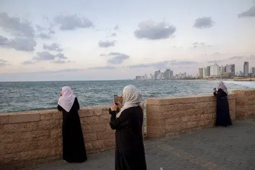 Palestinian citizens of Israel overlook the Mediterranean sea, in the mixed Arab-Jewish city of Jaffa, near Tel Aviv, Israel, Monday, Sept. 23, 2019. Israel's outgoing coalition was one of its most diverse and with it came a slew of progressive policies on the environment, LGBTQ issues and funding for the country's Arab minority. But the country's most likely incoming coalition is hoping to roll back many of the achievements pushed forward by the outgoing government, sparking concern by Israeli 