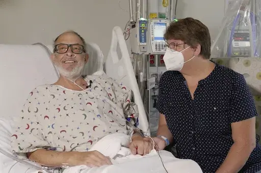 In this photo provided by the University of Maryland School of Medicine, Lawrence Faucette sits with wife, Ann, in the school's hospital in Baltimore, Md., in September 2023, before receiving a pig heart transplant. Lawrence Faucette, the second person to receive a transplanted heart from a pig has died, nearly six weeks after the highly experimental surgery, his doctors announced Tuesday, Oct. 31, 2023. (Mark Teske/University of Maryland School of Medicine via AP, File)