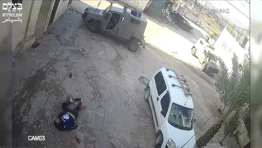 This image taken from video taken on Dec 8, 2023, in the Faraa refuge camp shows soldiers shooting down the men at close range when they did not appear to pose a threat. Security footage obtained by the Israeli human rights group B'Tselem shows two Israeli soldiers pursuing shooting the men — one while he was incapacitated and the other appearing to be unarmed — during a raid in a West Bank refugee camp. (B'Tselem via AP)