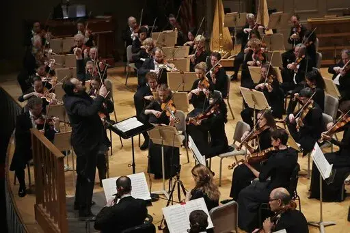 FILE — Andris Nelsons conducts a joint concert of the Boston Symphony Orchestra and Germany's visiting Leipzig Gewandhaus Orchestra at Symphony Hall, in Boston, Thursday, Oct. 31, 2019. Haunted by the horrors of the war in Ukraine, the Boston Symphony Orchestra is sounding a decidedly somber note as it prepares for its 2022-23 season. (AP Photo/Elise Amendola, File)