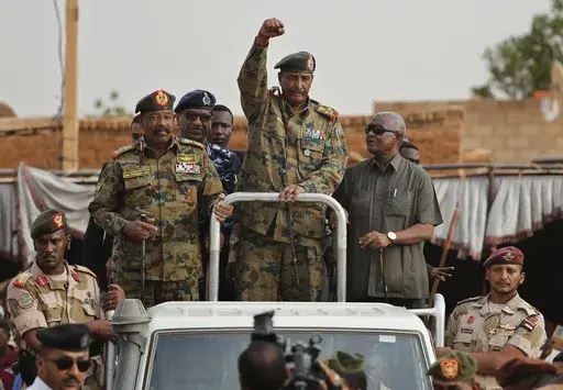 Sudanese Gen. Abdel-Fattah Burhan, head of the military council, waves to his supporters upon his arrival to attend a military-backed rally, in Omdurman district, west of Khartoum, Sudan, Saturday, June 29, 2019.(AP Photo/Hussein Malla, File)