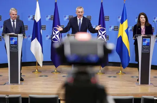 NATO Secretary General Jens Stoltenberg, center, participates in a media conference with Finland's Foreign Minister Pekka Haavisto, left, and Sweden's Foreign Minister Ann Linde, right, at NATO headquarters in Brussels, Jan. 24, 2022. The question of whether to join NATO is coming to a head in Finland and Sweden, where Russia's invasion of Ukraine has shattered the long-held belief that remaining outside the military alliance was the best way to avoid trouble with their giant neighbor. (AP Photo