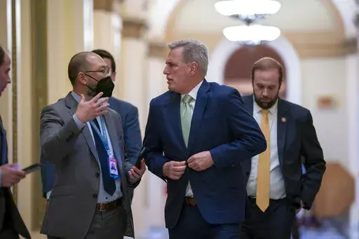 House Minority Leader Kevin McCarthy, R-Calif., talks to reporters as the House voted to hold former President Donald Trump advisers Peter Navarro and Dan Scavino in contempt of Congress over their monthslong refusal to comply with subpoenas from the committee investigating the Jan. 6 attack, at the Capitol in Washington, Wednesday, April 6, 2022. (AP Photo/J. Scott Applewhite)
