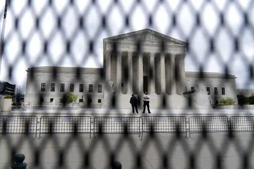 The U.S. Supreme Court is seen behind a fence who stands around the building on Thursday, May 5, 2022 in Washington. One proposal pending in Congress would provide additional security measures for the justices and another would offer more privacy and protection for all federal judges. (AP Photo/Jose Luis Magana, File)