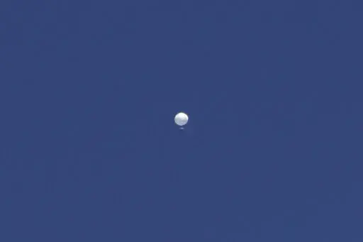 A balloon floats over Columbia, Mo., on Friday, Feb. 3, 2023. A huge, high-altitude Chinese balloon sailed across the U.S. on Friday, drawing severe Pentagon accusations of spying despite China's firm denials. (Anna Griffin/Missourian via AP)