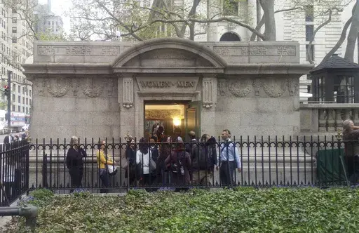 People line up to use a free public restroom, April 27, 2017, in New York. New York City Mayor Eric Adams announced Monday, June 3, 2024, a plan to build 46 new restrooms and renovate 36 existing ones located in city parks, adding to the city's roughly 1,000 such facilities over the next five years. (AP Photo/Verena Dobnik, File)