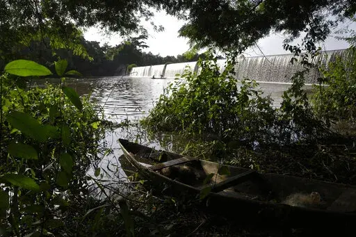 A fishing canoe sits near a dam that sources the sacred Osun River in Esa-Odo, Nigeria, on Saturday, May 28, 2022. The river, which flows through the dense forest of the Osun-Osogbo Sacred Grove — designated a UNESCO World Heritage Site in 2005 — is revered for its cultural and religious significance among the Yoruba-speaking people predominant in southwestern Nigeria, where the goddess Osun is widely worshipped. (AP Photo/Sunday Alamba)