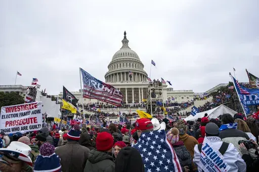 Rioters loyal to President Donald Trump rally at the U.S. Capitol in Washington, Jan. 6, 2021. Retired NASCAR driver Tighe Scott, his adult son and two other Pennsylvania men are facing felony charges stemming from confrontations with police during the Jan. 6, 2021, siege on the U.S. Capitol. (AP Photo/Jose Luis Magana, File)