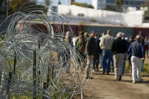 Concertina wire lines the path as members of Congress tour an area near the Texas-Mexico border, Jan. 3, 2024, in Eagle Pass, Texas. As congressional negotiators try to finalize a bipartisan deal on the border and immigration, their effort is drawing the wrath of hard-right lawmakers and former President Donald Trump. That vocal opposition threatens to unravel a delicate compromise. (AP Photo/Eric Gay, File)