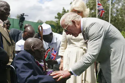 Britain's King Charles III, right, meets veteran Samwel Nthigai Mburia, who is believed to be 117 years old, during a visit to Kariokor World War II Commonwealth Cemetery in Nairobi, Kenya, Wednesday, Nov. 1, 2023. King Charles III has visited a war cemetery in Kenya, laying a wreath in honor of Kenyans who fought alongside the British in the two world wars. It came a day after the British monarch expressed “greatest sorrow and the deepest regret” for the violence of the colonial era. He gav