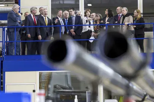 Mike Lamont, director for accelerators and technology, center left, and Fabiola Gianotti, center right, director general of the European Organization for Nuclear Research (CERN), speak with members of the U.S. House of Representatives in the Large Magnet Facility during a visit to CERN facilities in Meyrin, near Geneva, Switzerland, Friday, March 21, 2025. (Salvatore Di Nolfi/Keystone via AP)