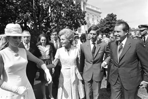 First lady Pat Nixon leads Princess Anne Thursday, July 16, 1970, from welcoming ceremonies at the White House. President Richard Nixon and Prince Charles walk with them. In the background are Julie and David Eisenhower. (AP Photo, File)