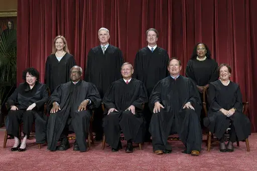 Members of the Supreme Court sit for a new group portrait following the addition of Associate Justice Ketanji Brown Jackson, at the Supreme Court building in Washington, Friday, Oct. 7, 2022. Bottom row, from left, Justice Sonia Sotomayor, Justice Clarence Thomas, Chief Justice of the United States John Roberts, Justice Samuel Alito, and Justice Elena Kagan. Top row, from left, Justice Amy Coney Barrett, Justice Neil Gorsuch, Justice Brett Kavanaugh, and Justice Ketanji Brown Jackson. (AP Photo/