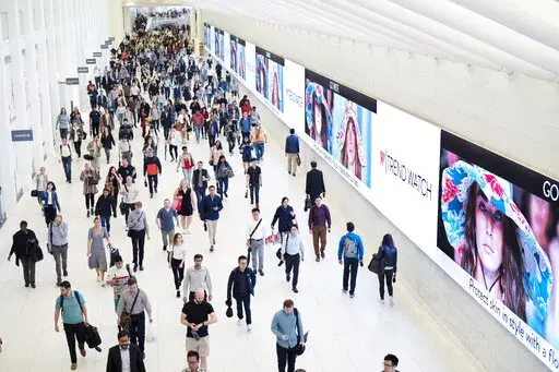 Commuters walk through a corridor in the World Trade Center Transportation Hub, June 21, 2019 in New York. Whether it’s a friend with a hot investment tip, a relative spouting off outdated directives about the way it “should” be done or a social media influencer touting a trendy financial product, money advice can be hit or miss. (AP Photo/Mark Lennihan, File)